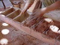 Throwing mud into handmade brick mold
